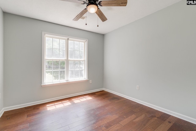 spare room featuring a ceiling fan, baseboards, and wood finished floors