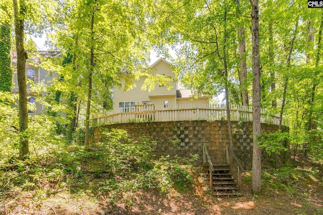 back of house featuring stairway