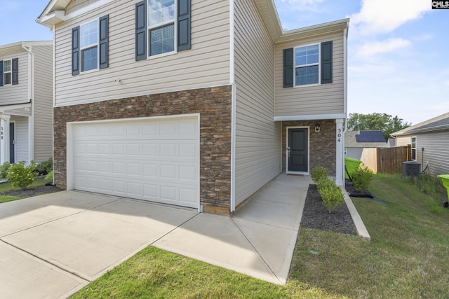 304 Sandbach Rd, Columbia, SC 29209 - view of front of property featuring a garage, fence, a front yard, stone siding, and driveway