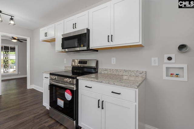 kitchen with a ceiling fan, baseboards, dark wood-style floors, stainless steel appliances, and white cabinetry