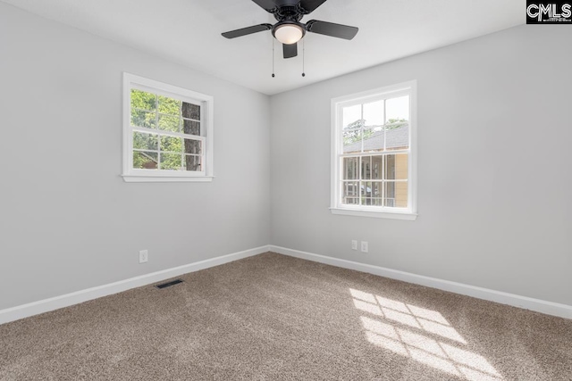 unfurnished room featuring a ceiling fan, baseboards, visible vents, and carpet