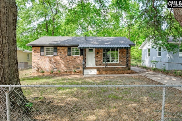 view of front of house with brick siding, a fenced backyard, roof with shingles, and crawl space