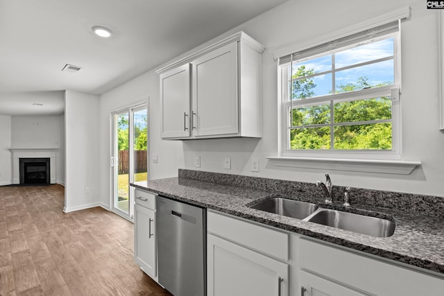 105 Maple Ct, Lugoff, SC 29073 - kitchen with stainless steel dishwasher, visible vents, white cabinets, a sink, and light wood finished floors