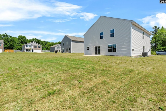 105 Maple Ct, Lugoff, SC 29073 - rear view of property with central air condition unit and a lawn