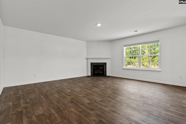 105 Maple Ct, Lugoff, SC 29073 - unfurnished living room with a fireplace with flush hearth, baseboards, dark wood-style floors, and visible vents