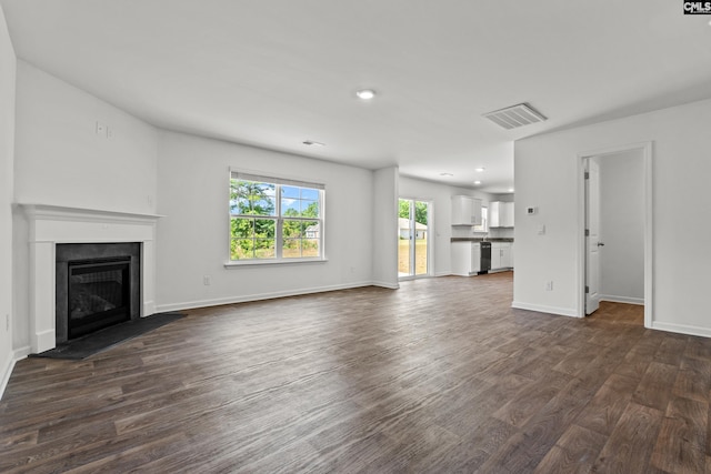 105 Maple Ct, Lugoff, SC 29073 - unfurnished living room featuring a fireplace with raised hearth, recessed lighting, baseboards, visible vents, and dark wood-style floors