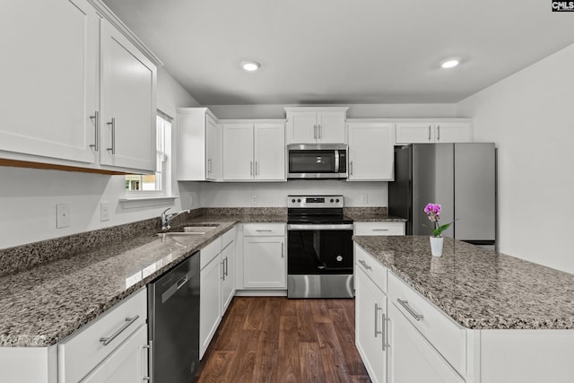 105 Maple Ct, Lugoff, SC 29073 - kitchen with white cabinets, dark wood-style flooring, a sink, stainless steel appliances, and stone counters