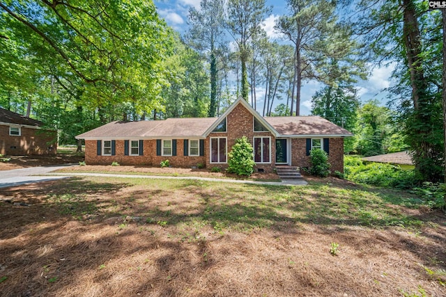 ranch-style house with roof with shingles, crawl space, and brick siding