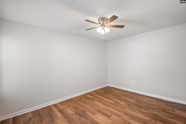 spare room with baseboards, a ceiling fan, and wood finished floors