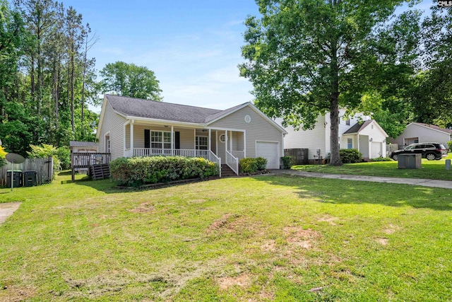 single story home with a garage, aphalt driveway, covered porch, and a front yard