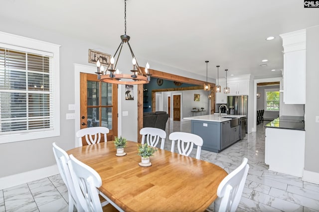 dining space featuring an inviting chandelier, recessed lighting, marble finish floor, and baseboards