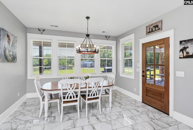 dining area featuring baseboards, visible vents, an inviting chandelier, and marble finish floor
