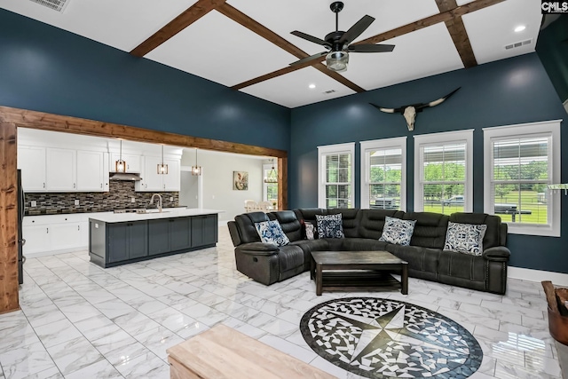 living room featuring a ceiling fan, beamed ceiling, visible vents, and marble finish floor