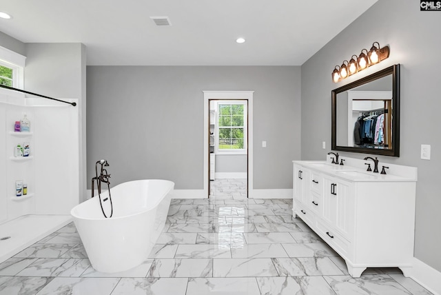 bathroom with a sink, baseboards, recessed lighting, and marble finish floor