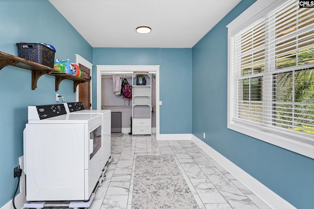 laundry area with baseboards, laundry area, marble finish floor, and washing machine and clothes dryer