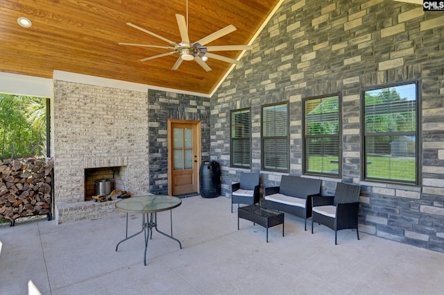 view of patio / terrace featuring an outdoor living space with a fireplace and ceiling fan