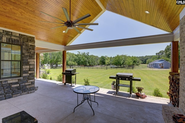 view of patio / terrace with a grill, fence, and a ceiling fan