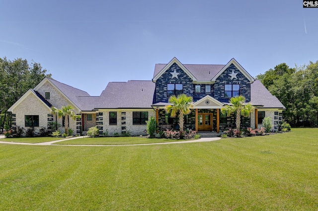 craftsman-style house with french doors, stone siding, and a front yard