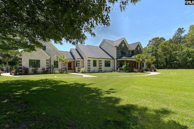 view of front of property featuring stone siding and a front lawn