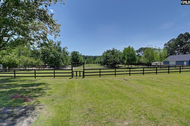 view of yard featuring a rural view and fence