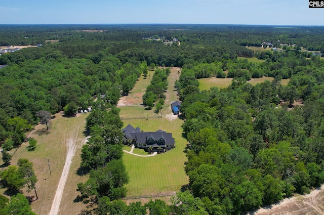 drone / aerial view featuring a forest view