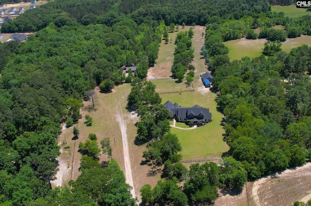 birds eye view of property with a wooded view