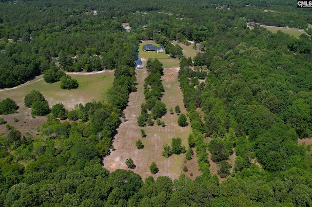 birds eye view of property featuring a view of trees