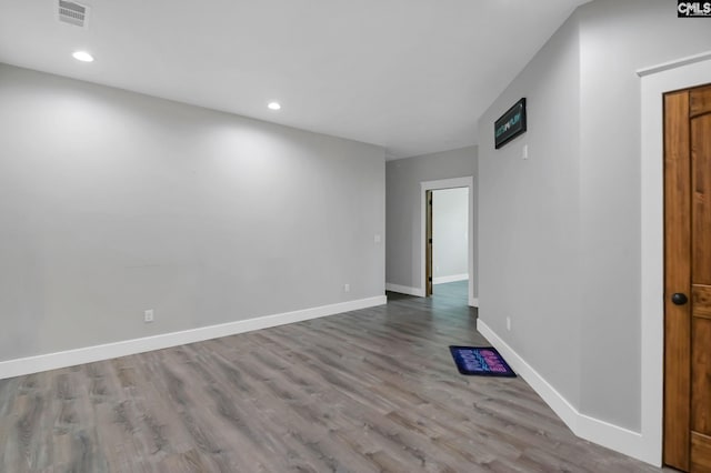 unfurnished room featuring recessed lighting, baseboards, visible vents, and wood finished floors