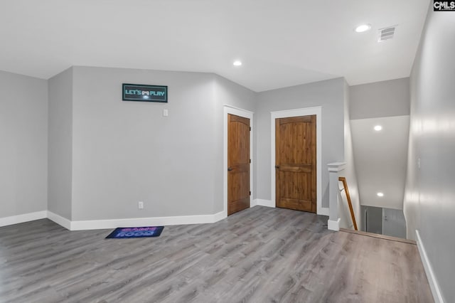 empty room with baseboards, recessed lighting, visible vents, and wood finished floors