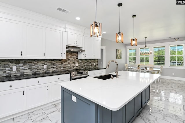kitchen featuring a sink, marble finish floor, white cabinets, and tasteful backsplash