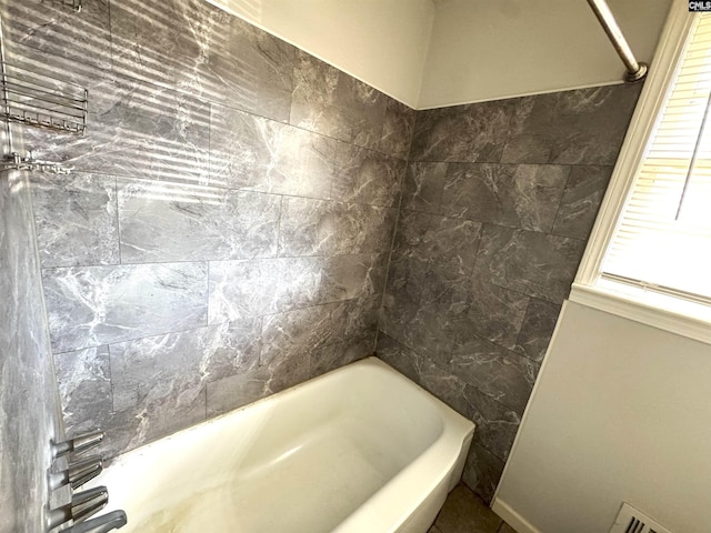 bathroom with visible vents and bathtub / shower combination