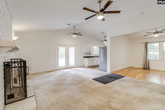 1916 Chandler Ave, Columbia, SC 29210 - unfurnished living room featuring baseboards, ceiling fan, vaulted ceiling, and light carpet
