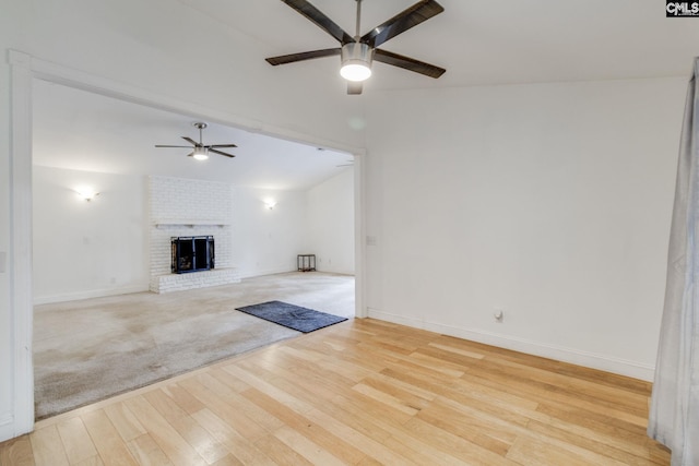 1916 Chandler Ave, Columbia, SC 29210 - unfurnished living room with a brick fireplace, wood finished floors, lofted ceiling, baseboards, and ceiling fan
