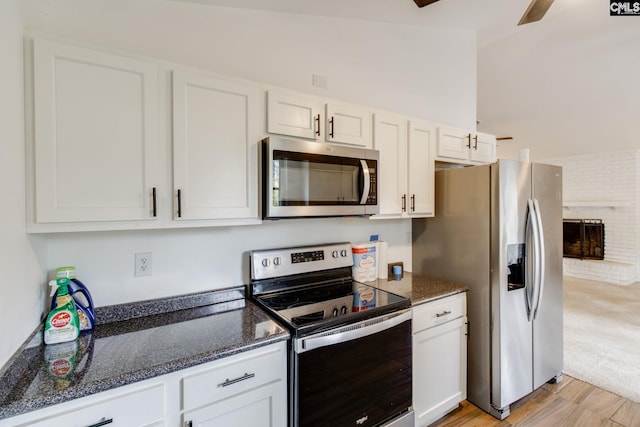 1916 Chandler Ave, Columbia, SC 29210 - kitchen featuring ceiling fan, appliances with stainless steel finishes, white cabinetry, dark stone counters, and light wood-style flooring