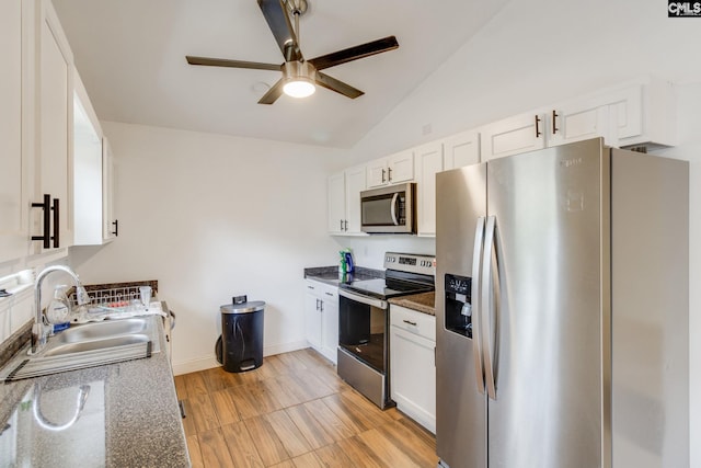 1916 Chandler Ave, Columbia, SC 29210 - kitchen featuring a sink, white cabinetry, a ceiling fan, appliances with stainless steel finishes, and vaulted ceiling