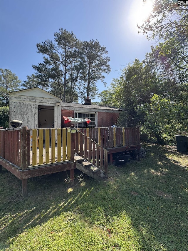 729 Vernon St, Columbia, SC 29203 - rear view of property featuring a chimney, a lawn, a storage shed, a wooden deck, and an outdoor structure