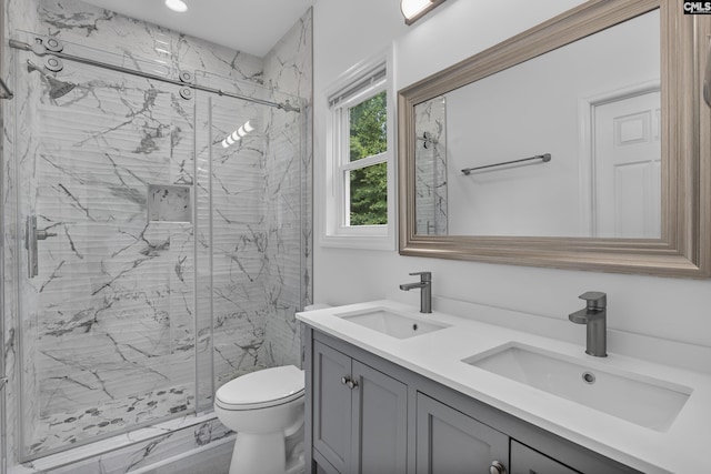 bathroom with a sink, a marble finish shower, and toilet
