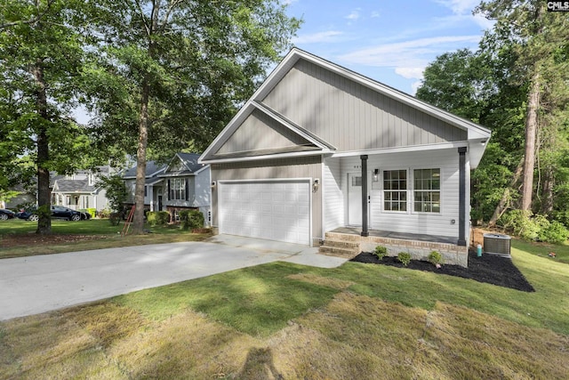 view of front of house featuring a garage, a front yard, concrete driveway, a porch, and central air condition unit
