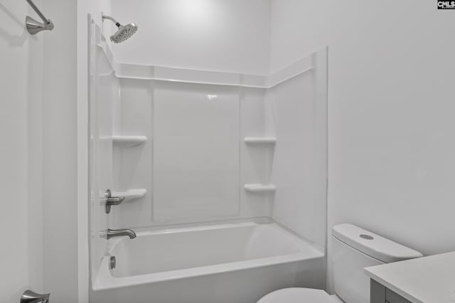 bathroom with vanity, toilet, and  shower combination