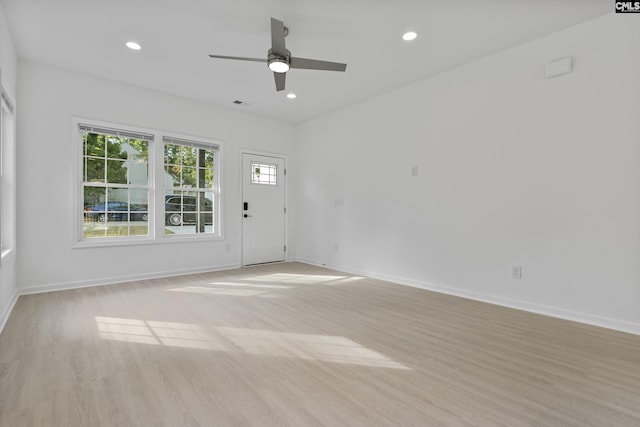 interior space with light wood-style floors, baseboards, ceiling fan, and recessed lighting