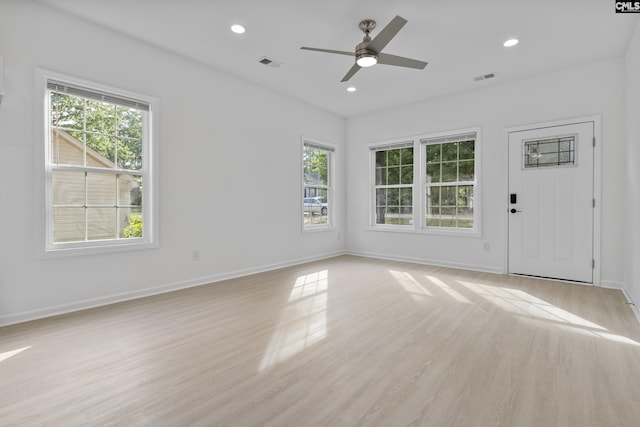unfurnished living room featuring visible vents, baseboards, recessed lighting, a ceiling fan, and light wood-style flooring