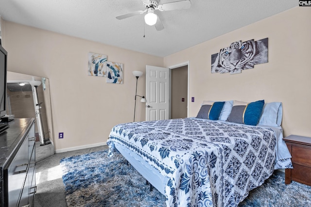 bedroom with carpet floors, ceiling fan, baseboards, and a textured ceiling