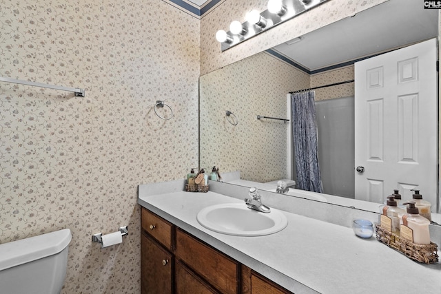 bathroom with toilet, wallpapered walls, curtained shower, and vanity
