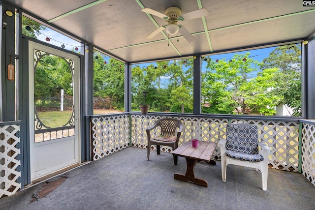 sunroom featuring ceiling fan and a healthy amount of sunlight