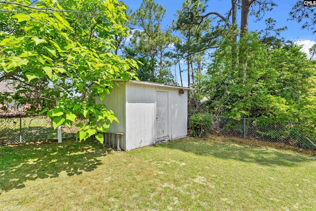 view of shed featuring fence