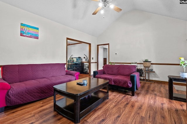 living area with a ceiling fan, wood finished floors, and high vaulted ceiling