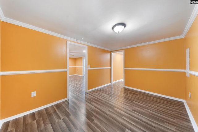 unfurnished room with baseboards, ornamental molding, and wood finished floors
