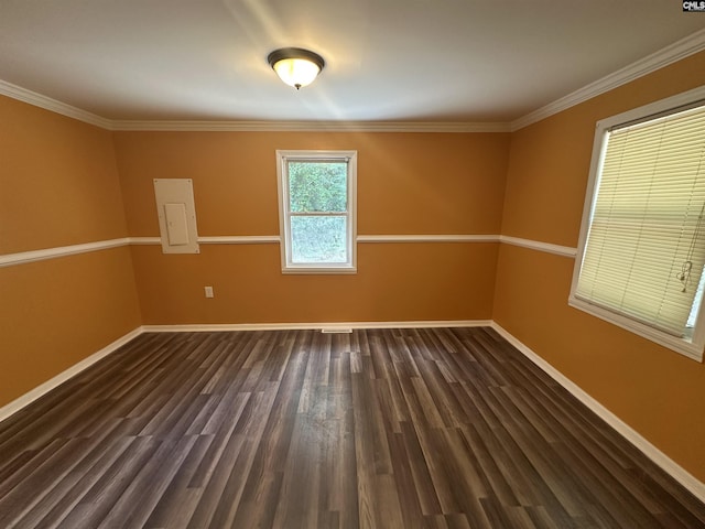unfurnished room with electric panel, ornamental molding, baseboards, and dark wood finished floors