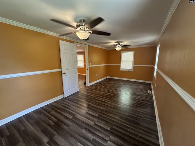 unfurnished room with visible vents, dark wood finished floors, ceiling fan, crown molding, and baseboards