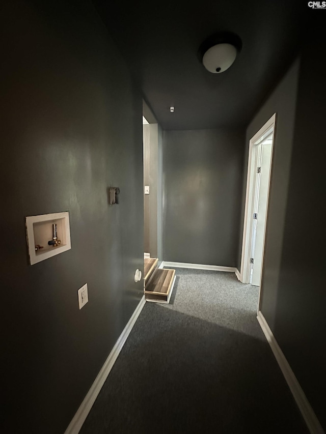 hallway featuring baseboards and carpet